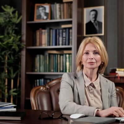 Mature businesswoman at desk in office, portraying leadership and professionalism.
